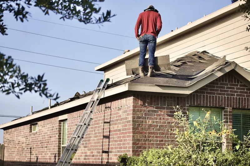 Professional roofer working on a residential roof in Schuyler Hills